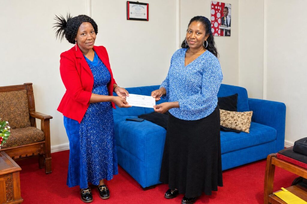 Inua Women CBO receiving cheque